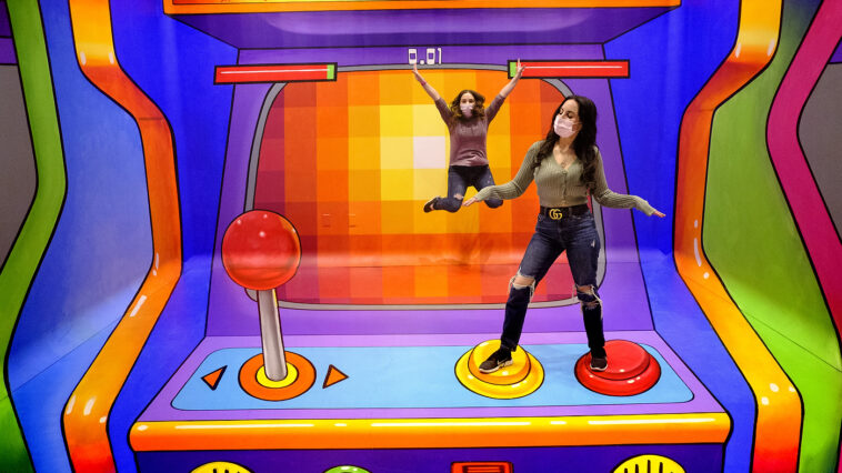 Vanessa Burrell, left, and Tara Lenza play in the 'Gamer' installation. American Dream has partnered with internationally -renowned street painter and author Tracy Lee Stum to open the first-ever TiLT Museum at American Dream, bringing art and enjoyment to all through hand-painted, experiential three-dimensional artworks. Thursday, April 22, 2021. East Rutherford, N.J.